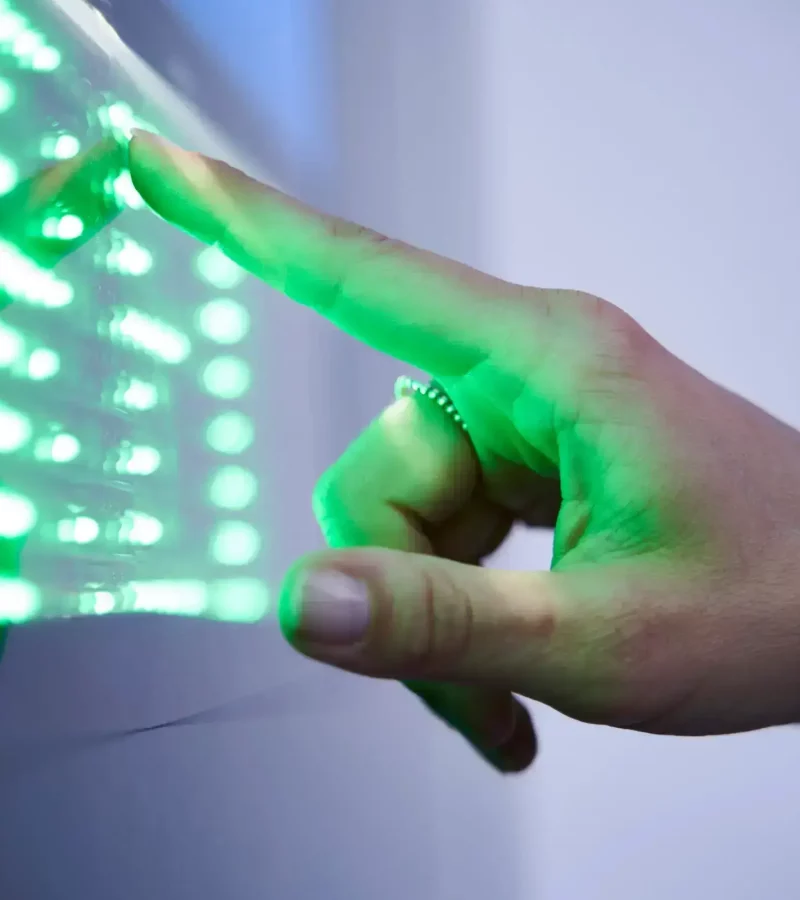 Detail of finger touching green led touchscreen